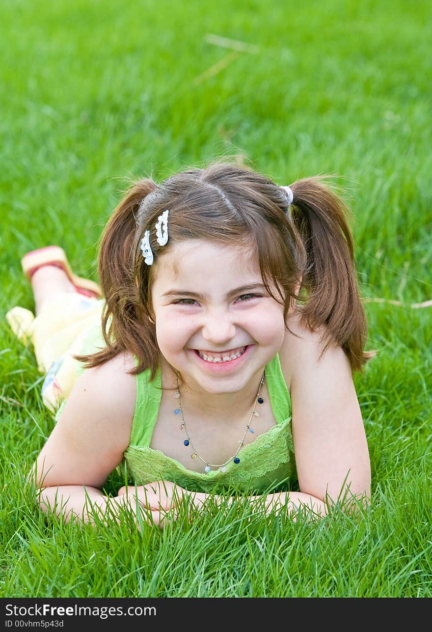 Cute Little Girl Laying in the Grass