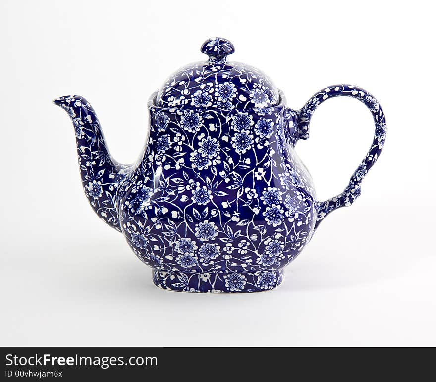 Ornate blue china teapot isolated on white. Ornate blue china teapot isolated on white