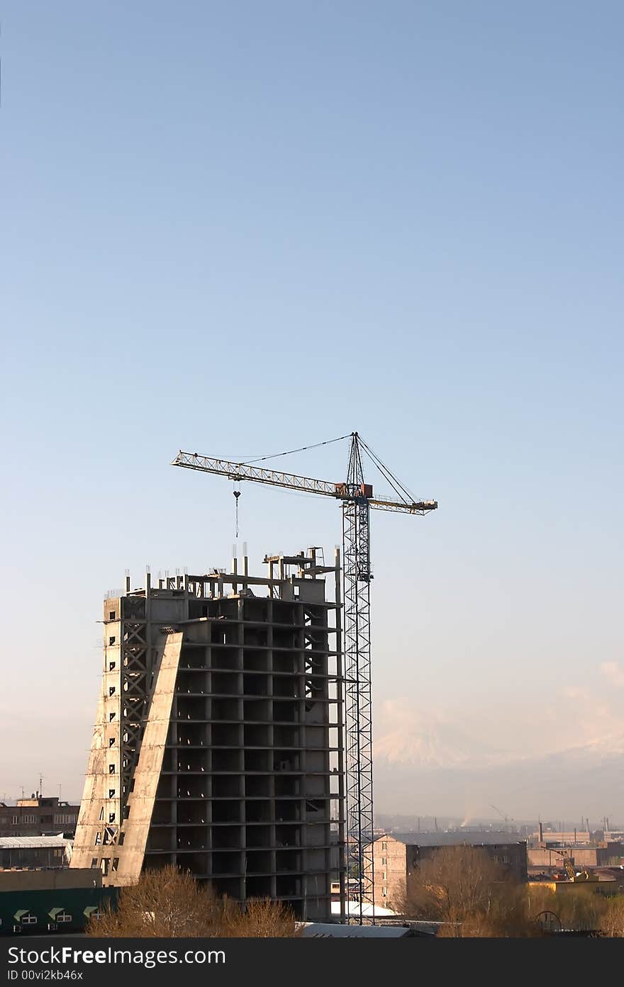 Large crane build new house over blue sky. Large crane build new house over blue sky