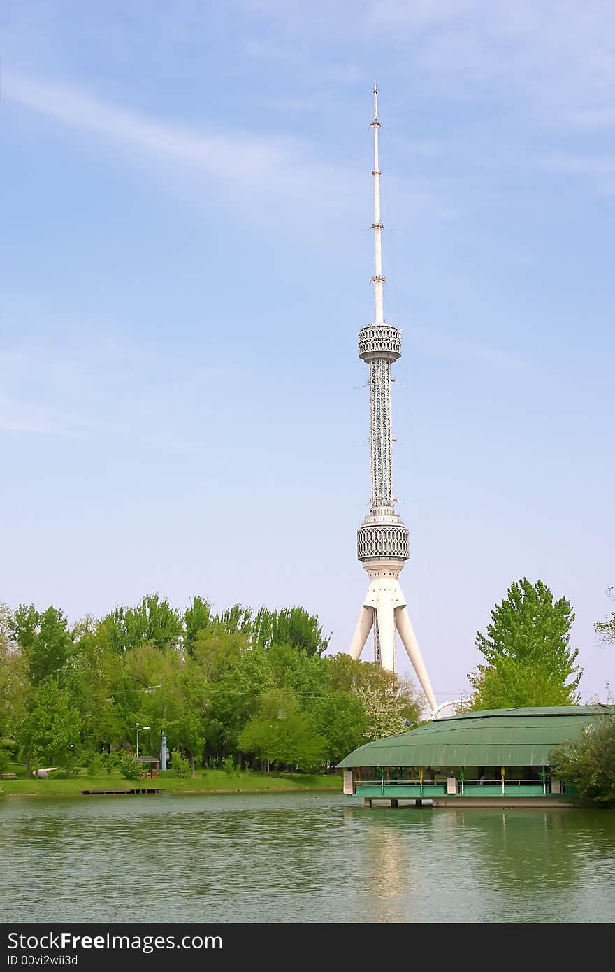 Large tv aerial near river over blue sky