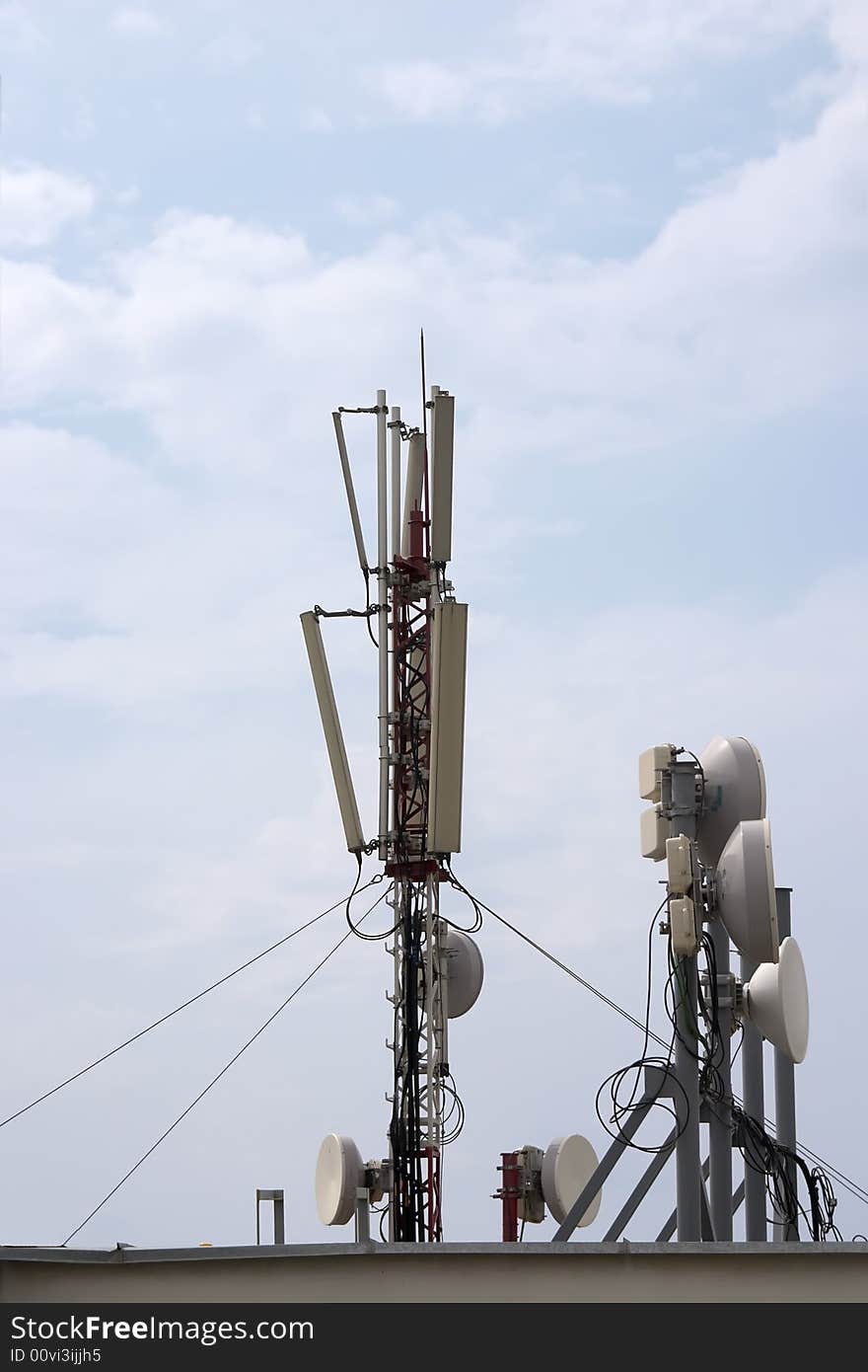 Cell antenna on roof over blue sky. Cell antenna on roof over blue sky