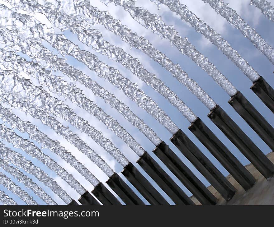 Detail from a fountain - water background in blue sky