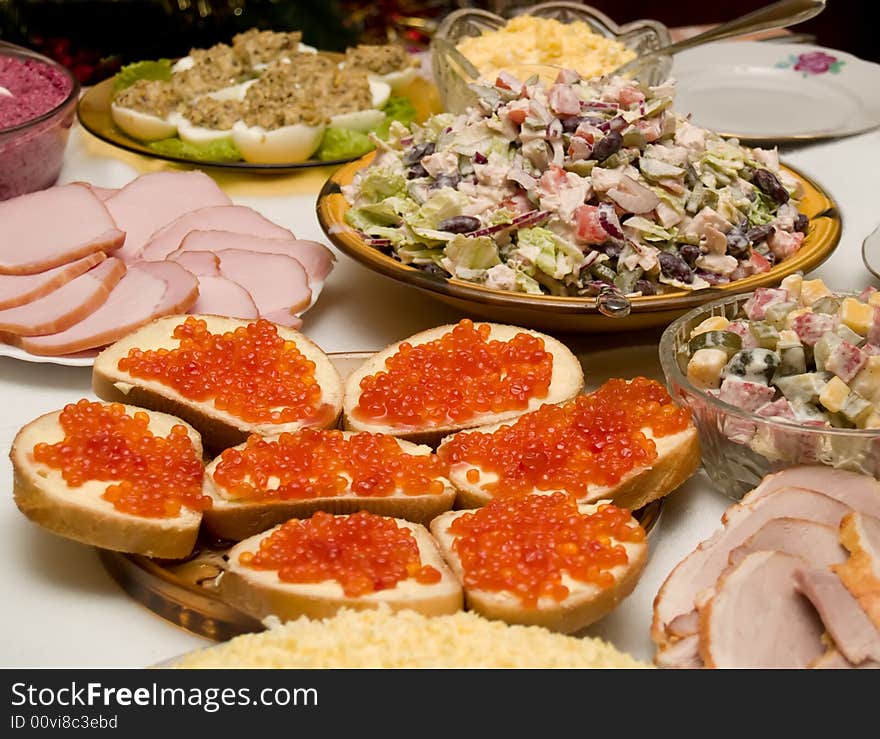 Table covered for a celebratory dinner. Sandwiches with red caviar.