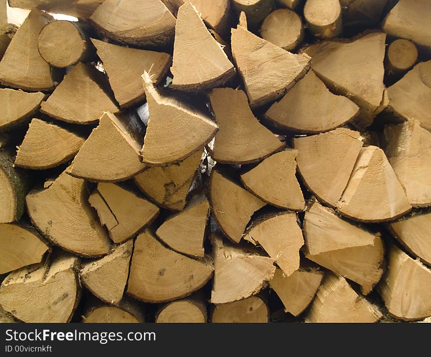 Stacked timber logs fuel for fire. Wooden background