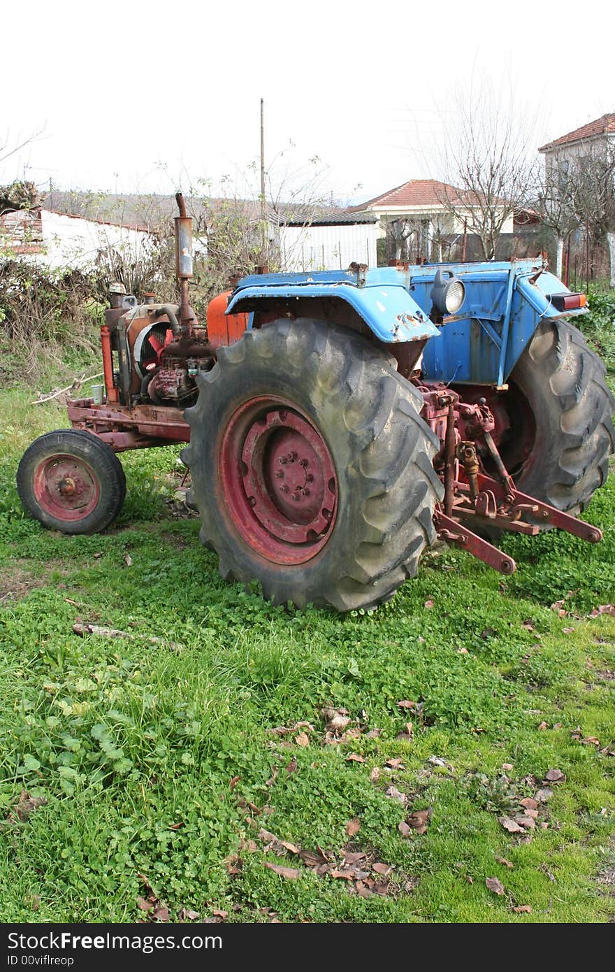 Old trakter in a green farm