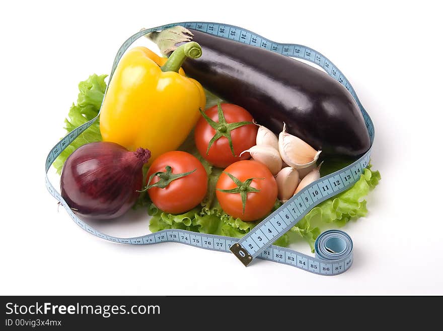 A photo of fresh vegetables binded with measure tape. A photo of fresh vegetables binded with measure tape