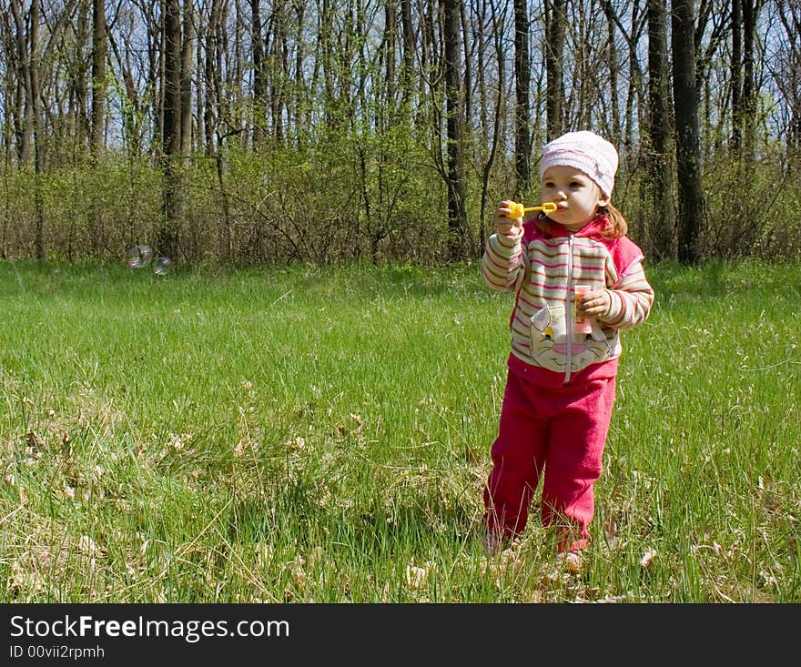 Nice child blowing soap bubbles