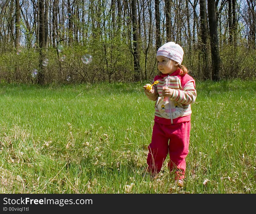 Nice child blowing soap bubbles. Nice child blowing soap bubbles