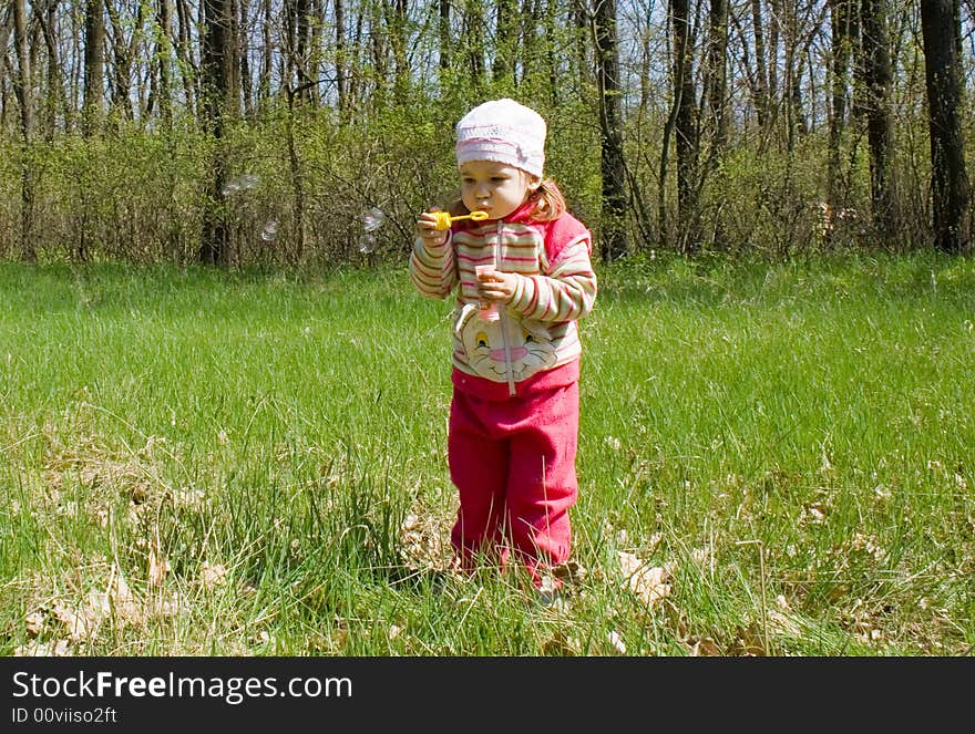 Little child blowing soap bubbles. Little child blowing soap bubbles