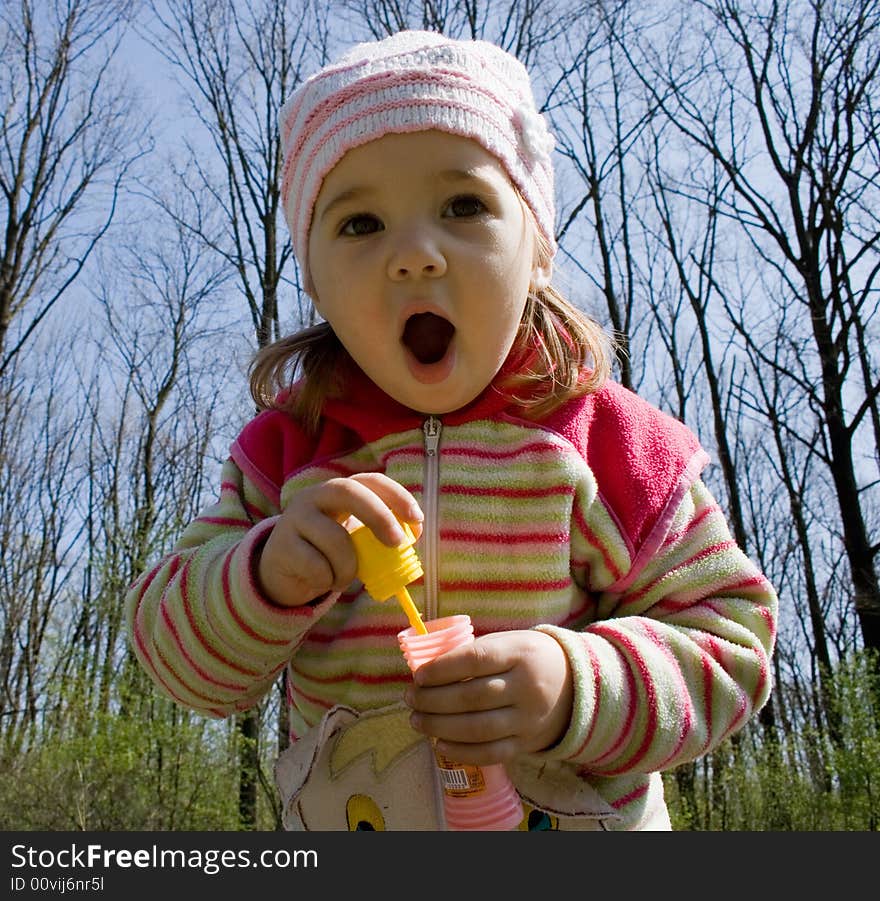 Little girl blowing soap bubbles