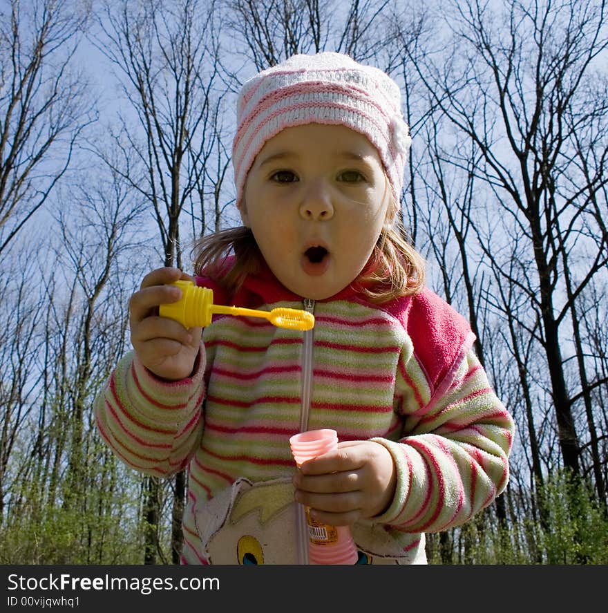 Little girl blowing soap bubbles