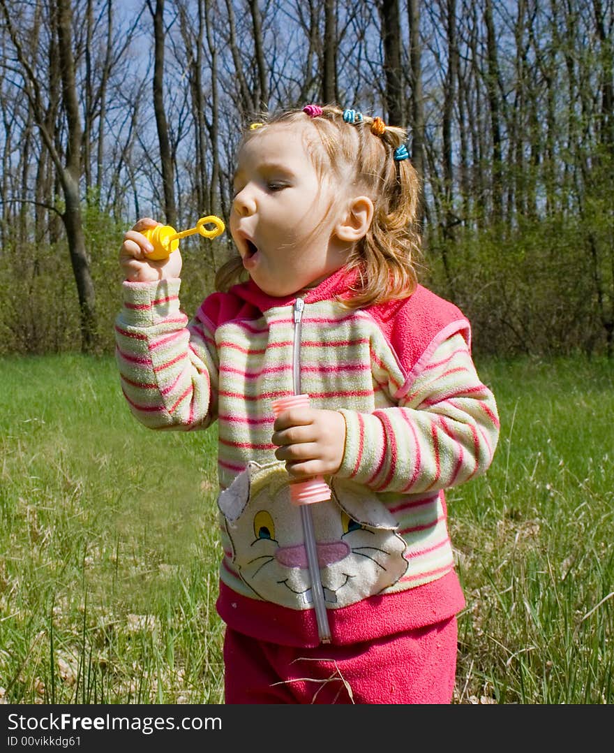 Little girl blowing soap bubbles. Little girl blowing soap bubbles