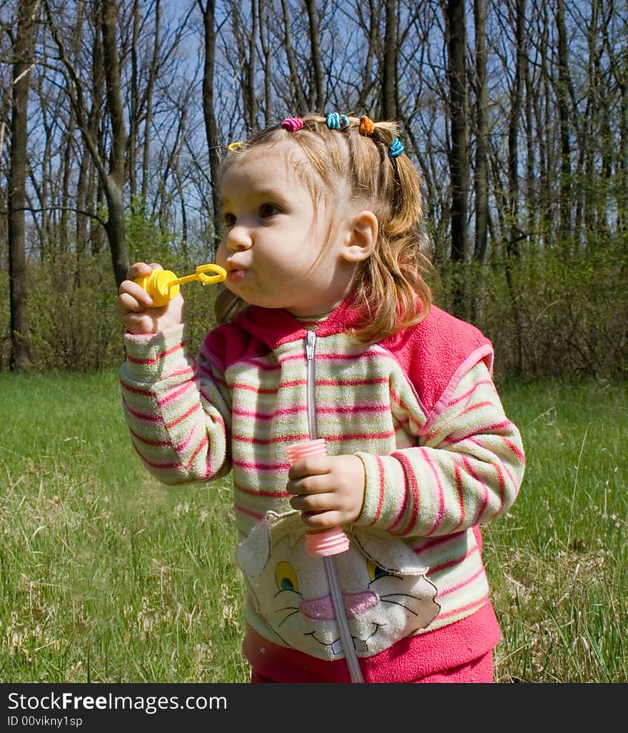 Little child blowing soap bubbles. Little child blowing soap bubbles