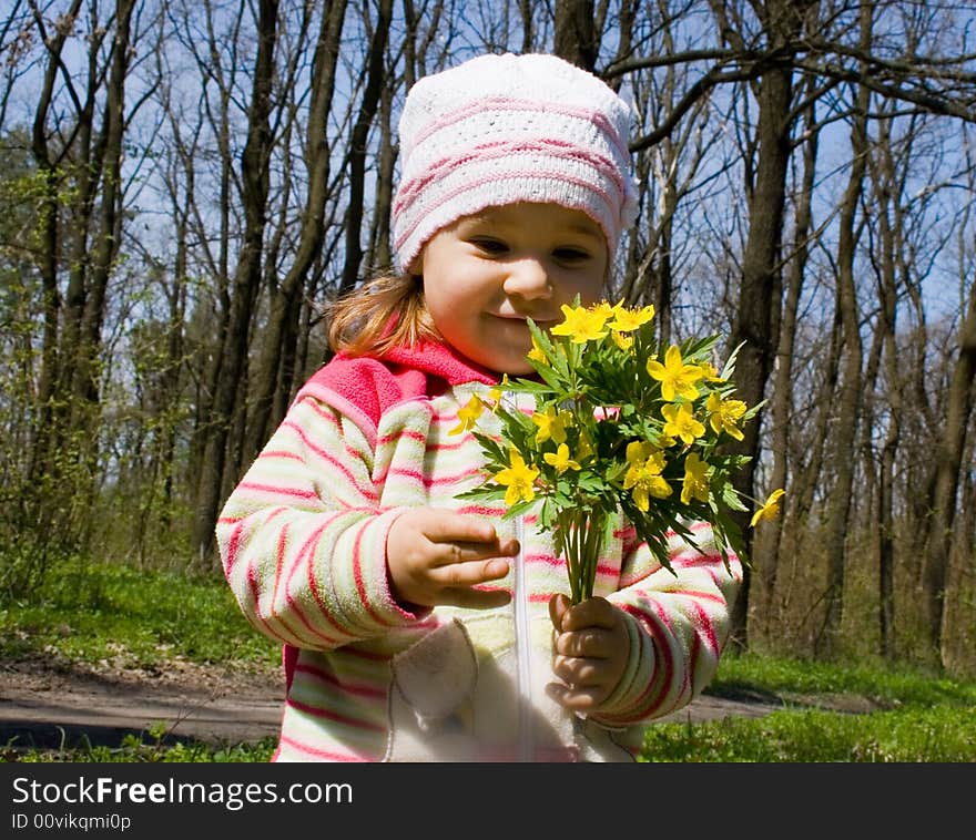 Little girl with bunch of flowers