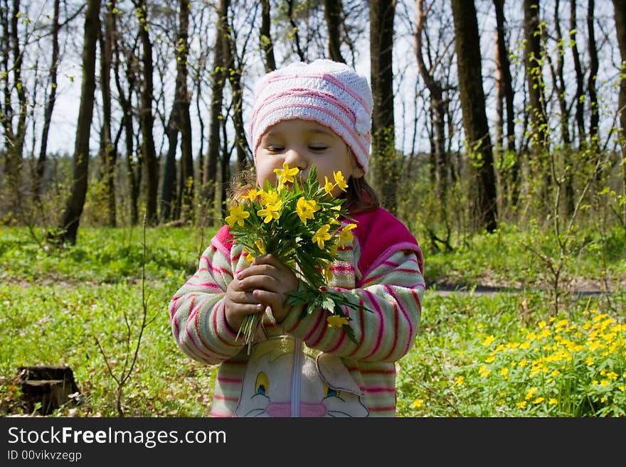 Little girl with bunch of flowers