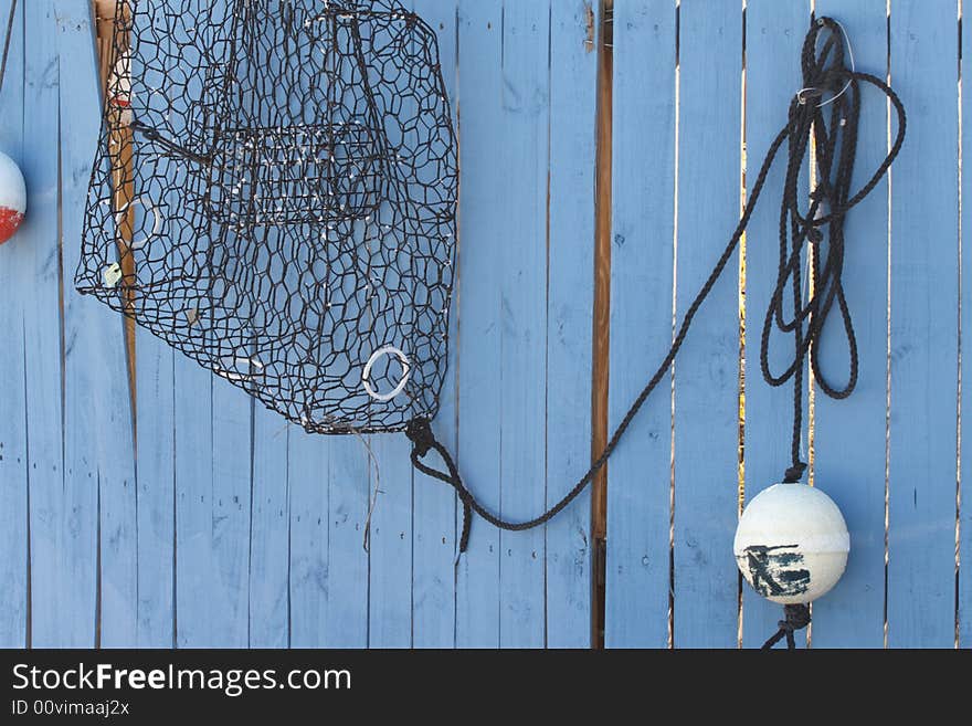 Crab abd lobster trap on wooden wall and marker buoy. Crab abd lobster trap on wooden wall and marker buoy