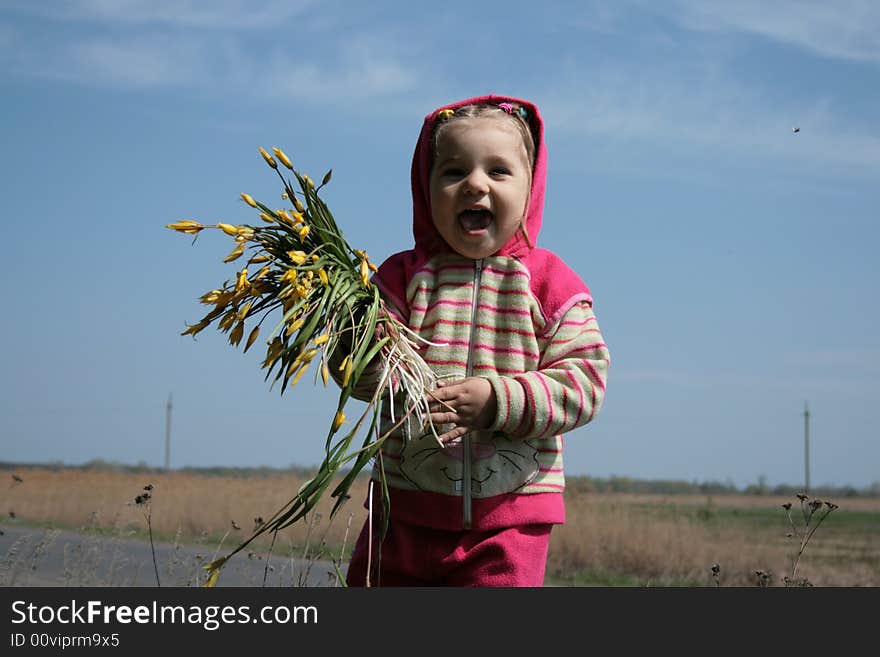 Little cute girl with bunch of flowers laughing. Little cute girl with bunch of flowers laughing