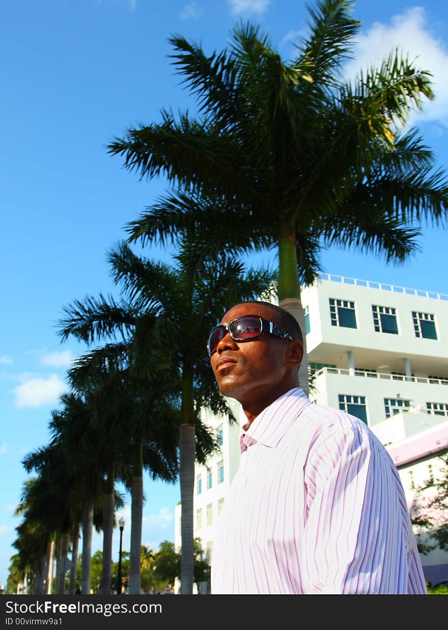 Businessman walking with palms in the background. Businessman walking with palms in the background.