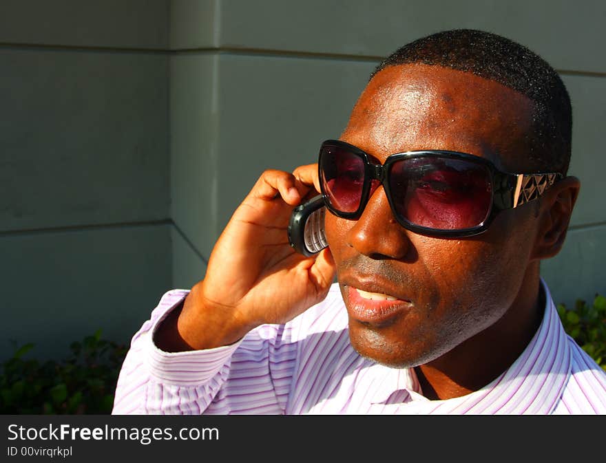 Attractive young businessman on the phone. Attractive young businessman on the phone.