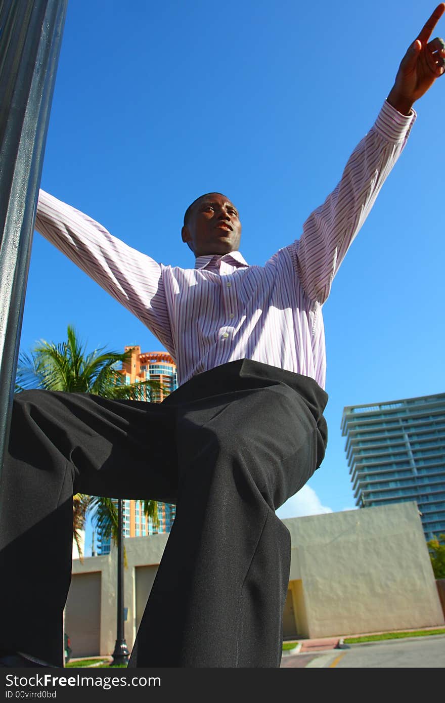 Man hanging from a light pole