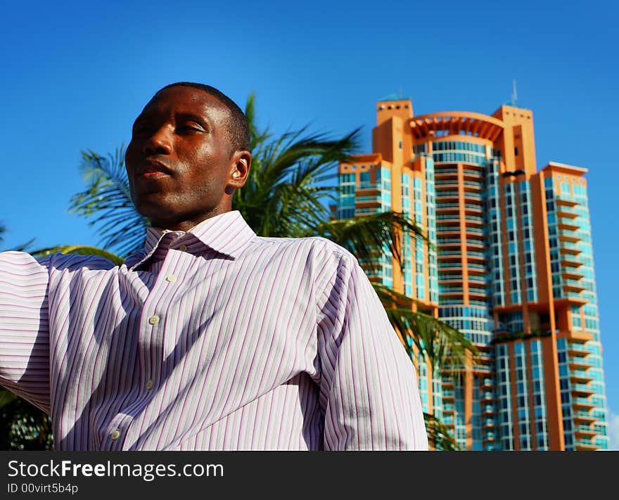 Man appearing to be tall with a building behind him. Man appearing to be tall with a building behind him.