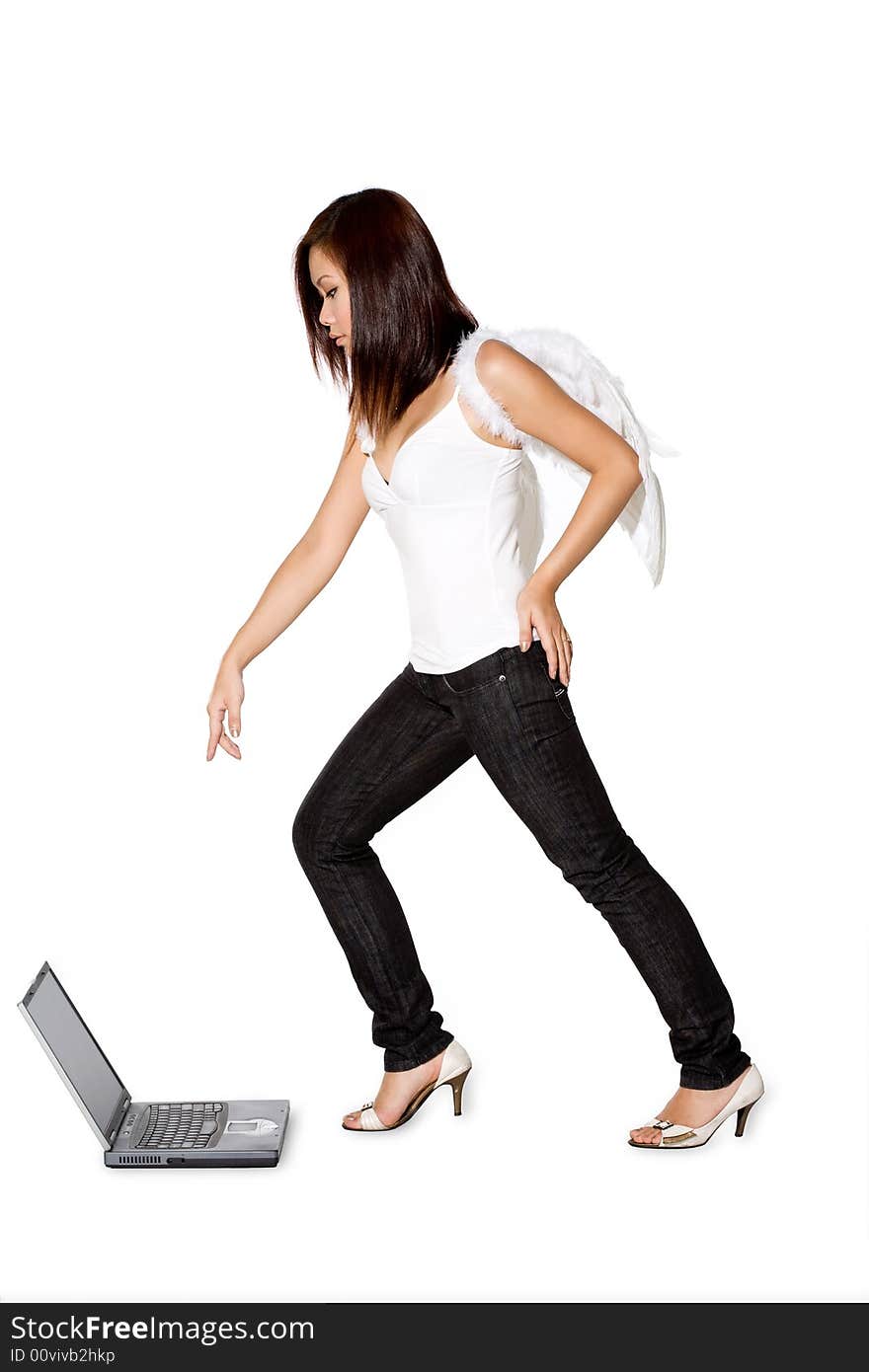 Woman with angel wings pointing while looking on the laptop. Woman with angel wings pointing while looking on the laptop