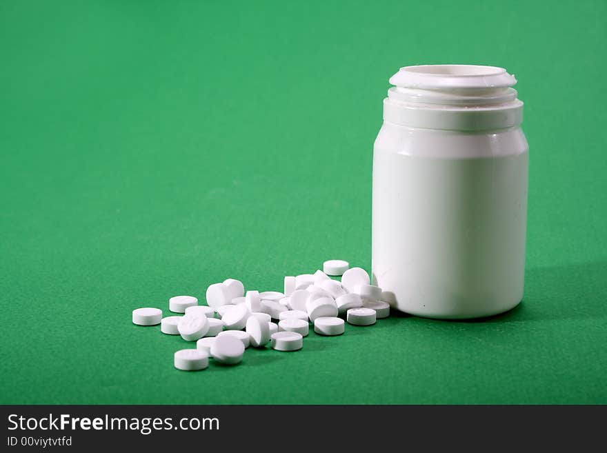 Medication next to a open bottle. Medication next to a open bottle.