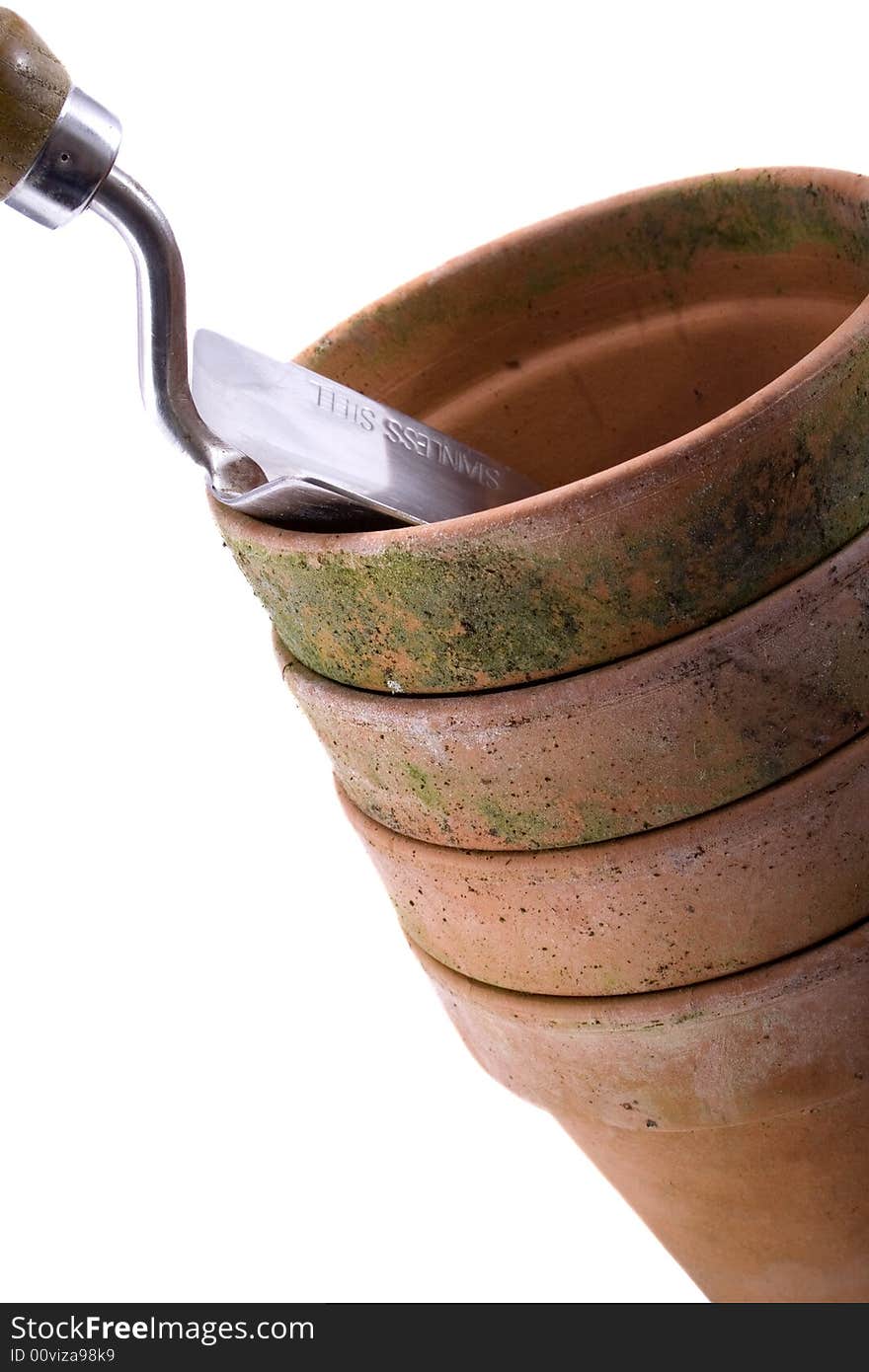 Four terracota pots and a hand spade. Four terracota pots and a hand spade.