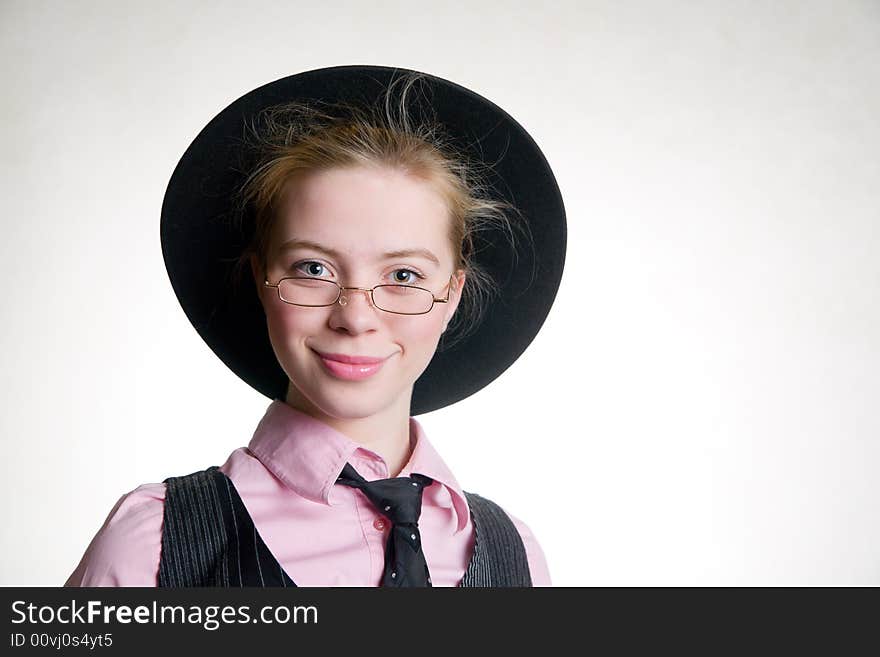 Portrait of young smiling business woman in black hat and suit