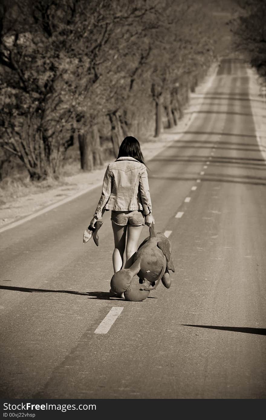 Young woman left behind with her teddy bear. Young woman left behind with her teddy bear.