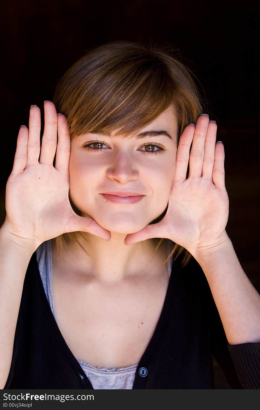 Beautiful blond woman framing herself with her hands. Beautiful blond woman framing herself with her hands