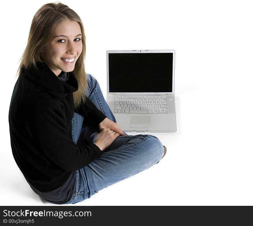 Smiling young woman in front of laptop. Smiling young woman in front of laptop.