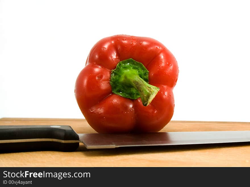 Red pepper and knife isolated on white