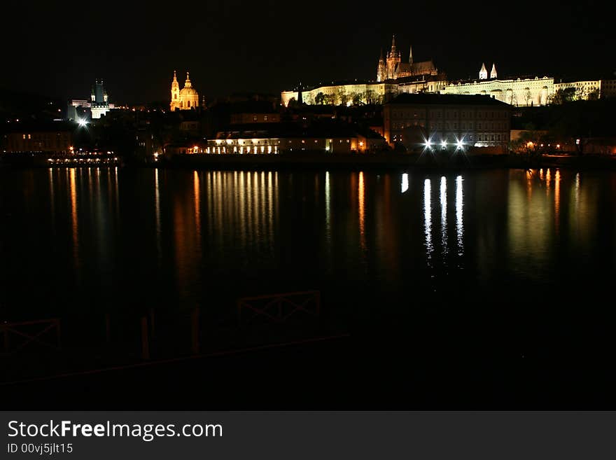 Night scene of Prague Castle, reflection on water, Vltava river