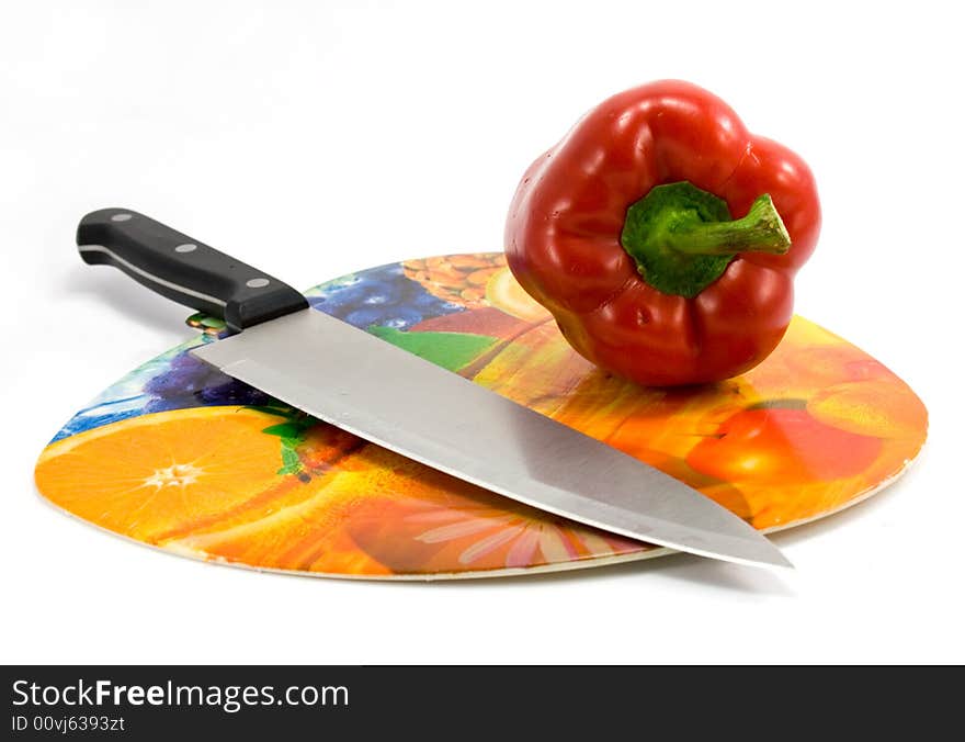 Red pepper and knife isolated on white