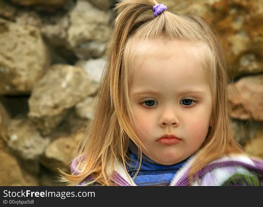 Little girl walks in the spring on a young grass