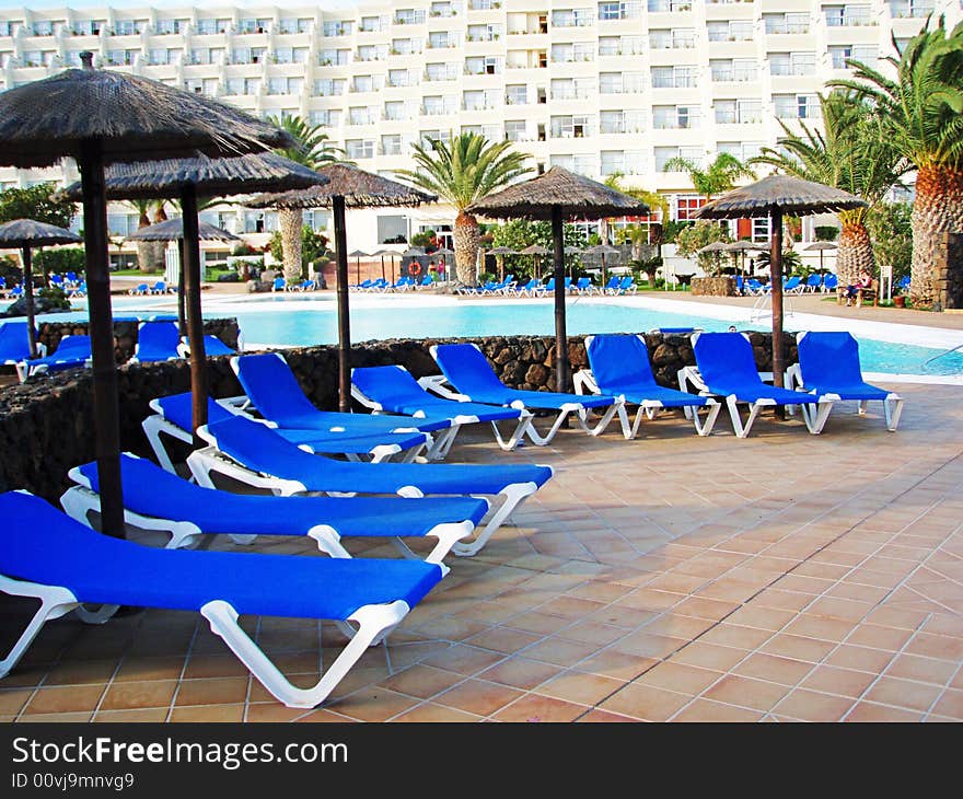 SPA resort on the Lanzarote. a pool area with blue chaise longue. SPA resort on the Lanzarote. a pool area with blue chaise longue