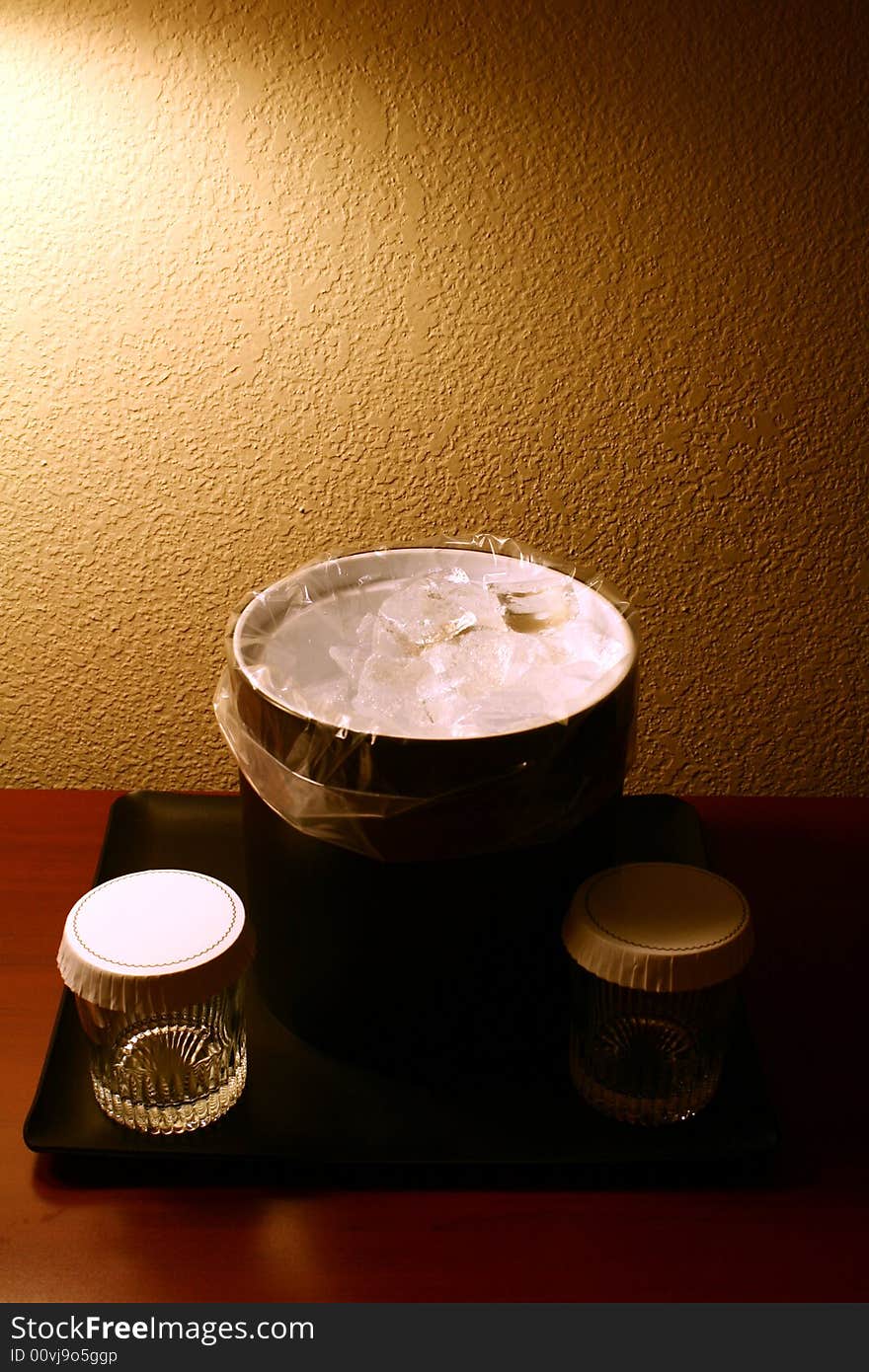 A photograph of a hotel ice bucket and glasses.