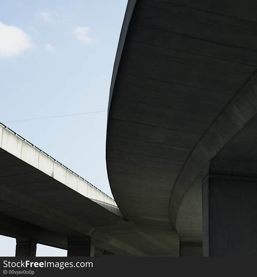 Under a concrete highway with blue sky