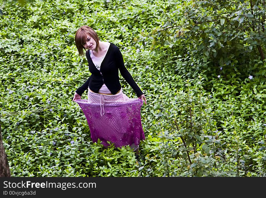 Cheerful young woman surrounded by nature. Cheerful young woman surrounded by nature.