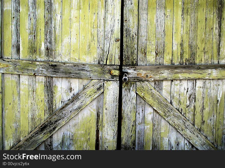 Detailed closeup of old wooden door on a building with a lock. Detailed closeup of old wooden door on a building with a lock