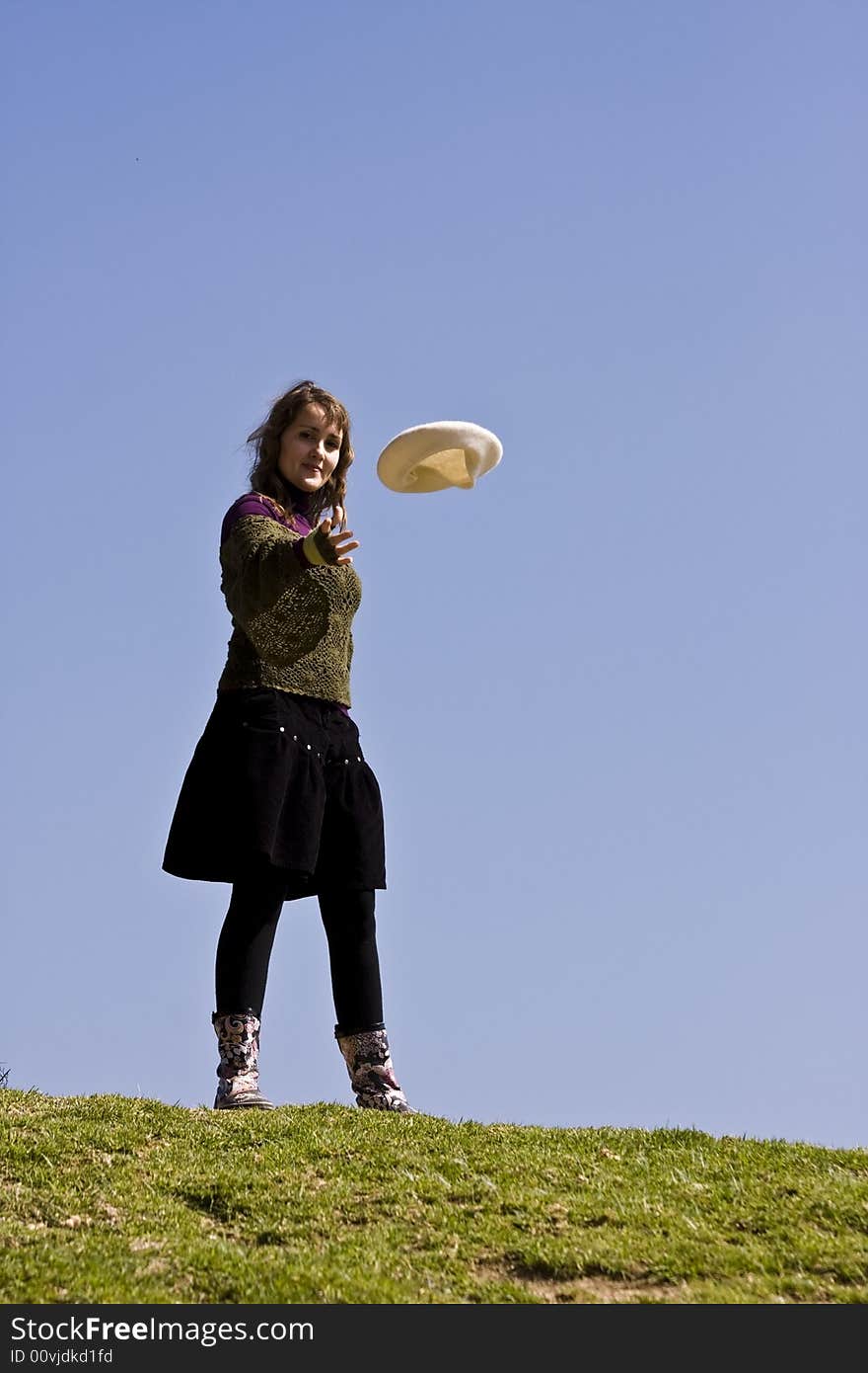 Happy young woman throwing her beret