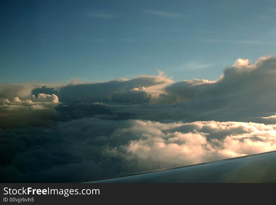 The dusk over clouds from a plane. The dusk over clouds from a plane