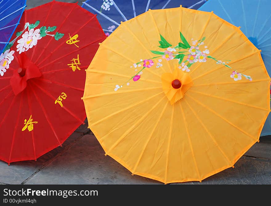 The ornamental sun umbrella made of colorful cloth with Chinese characters and paintings. The ornamental sun umbrella made of colorful cloth with Chinese characters and paintings.