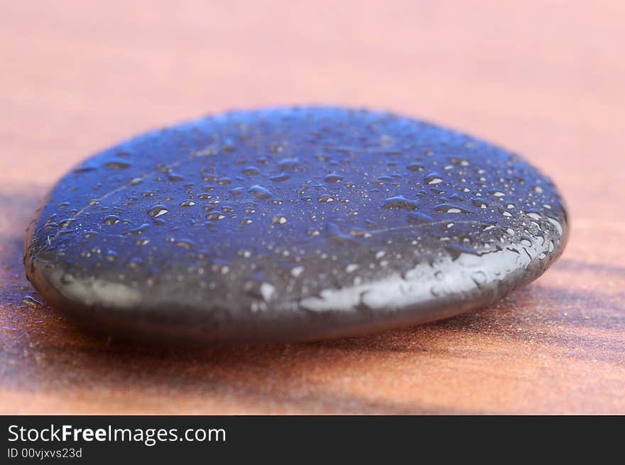 A black therapy stones with waterdrops