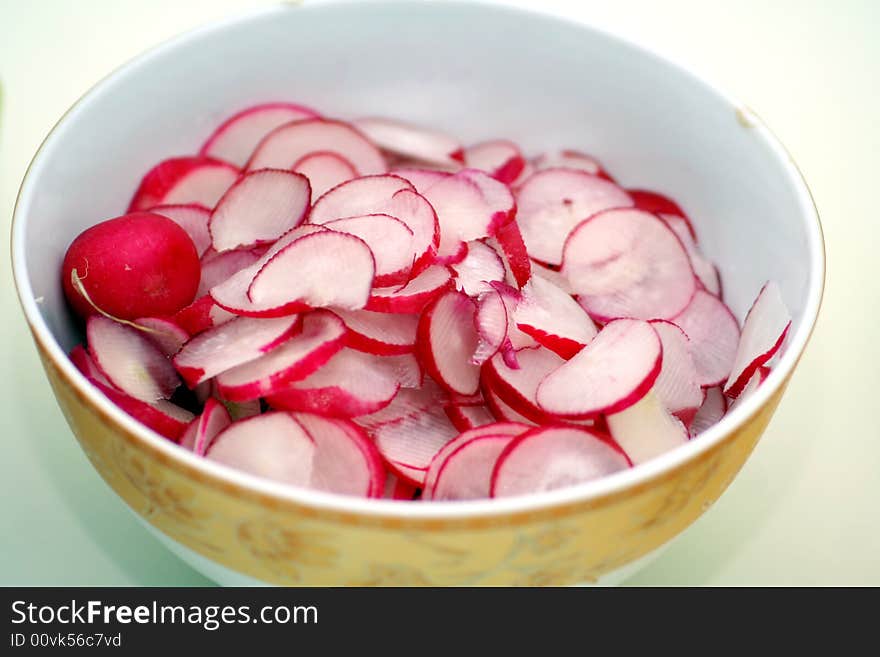 A salad of fresh red radishes with oil and vinegar