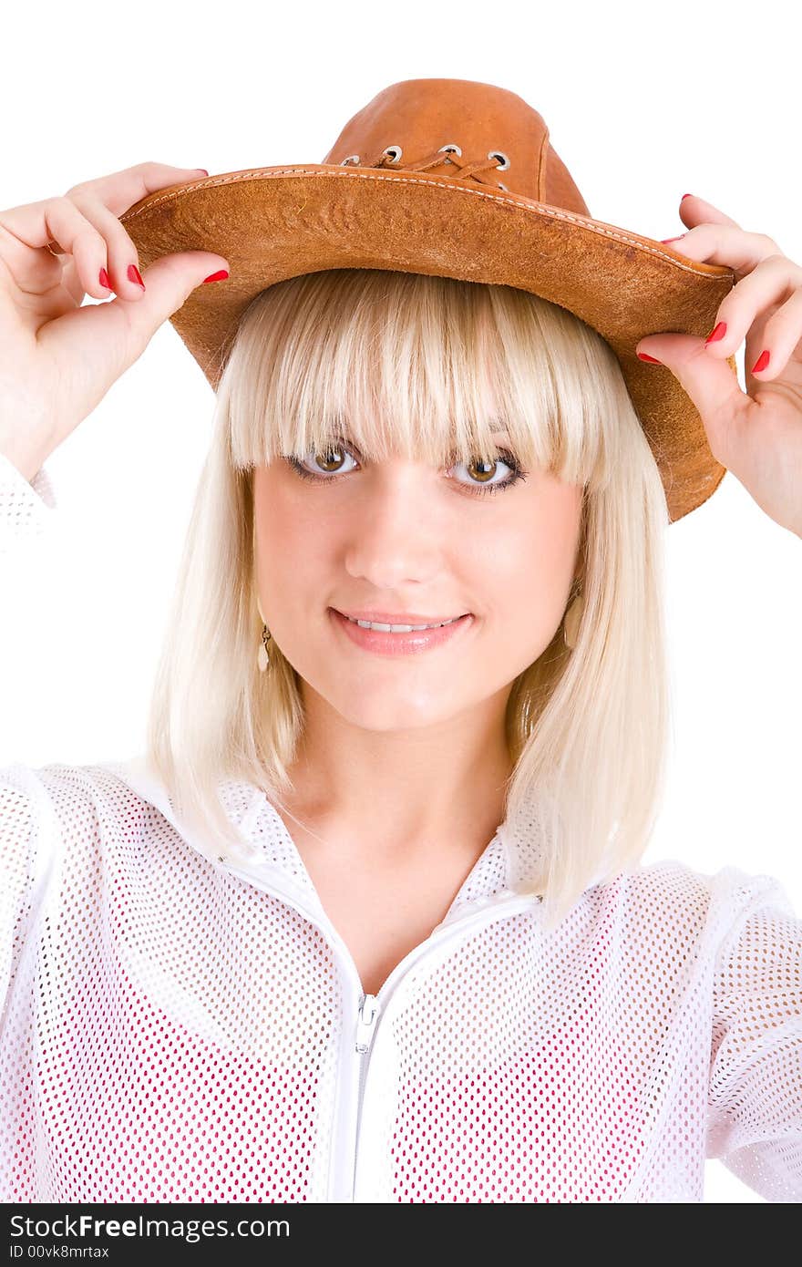 Blond girl puts on a cowboy hat. Blond girl puts on a cowboy hat