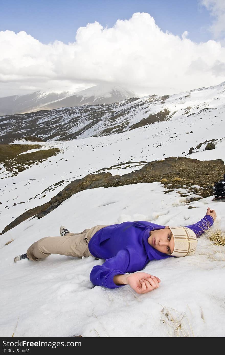 Man in casual clothing relaxed over the snow. Man in casual clothing relaxed over the snow