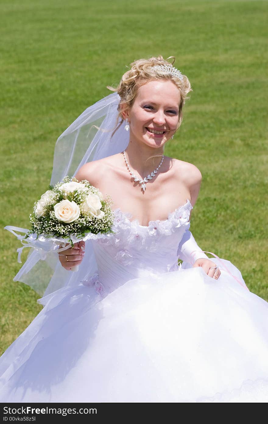 Blond bride runs with bouquet of white roses. Blond bride runs with bouquet of white roses