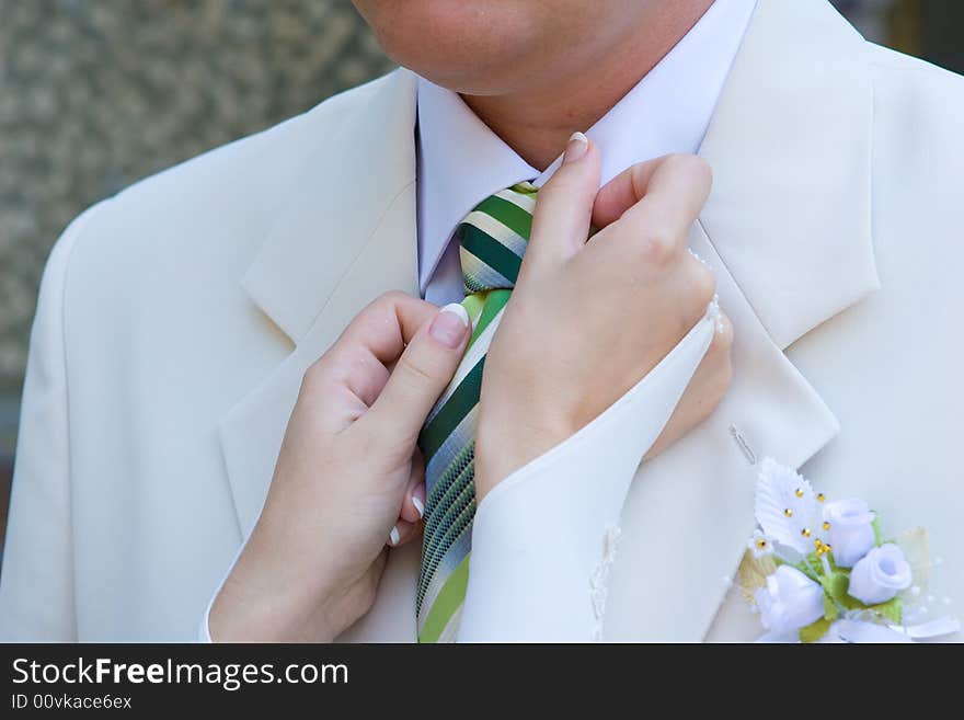 Hands of girl help to man put on necktie. Hands of girl help to man put on necktie